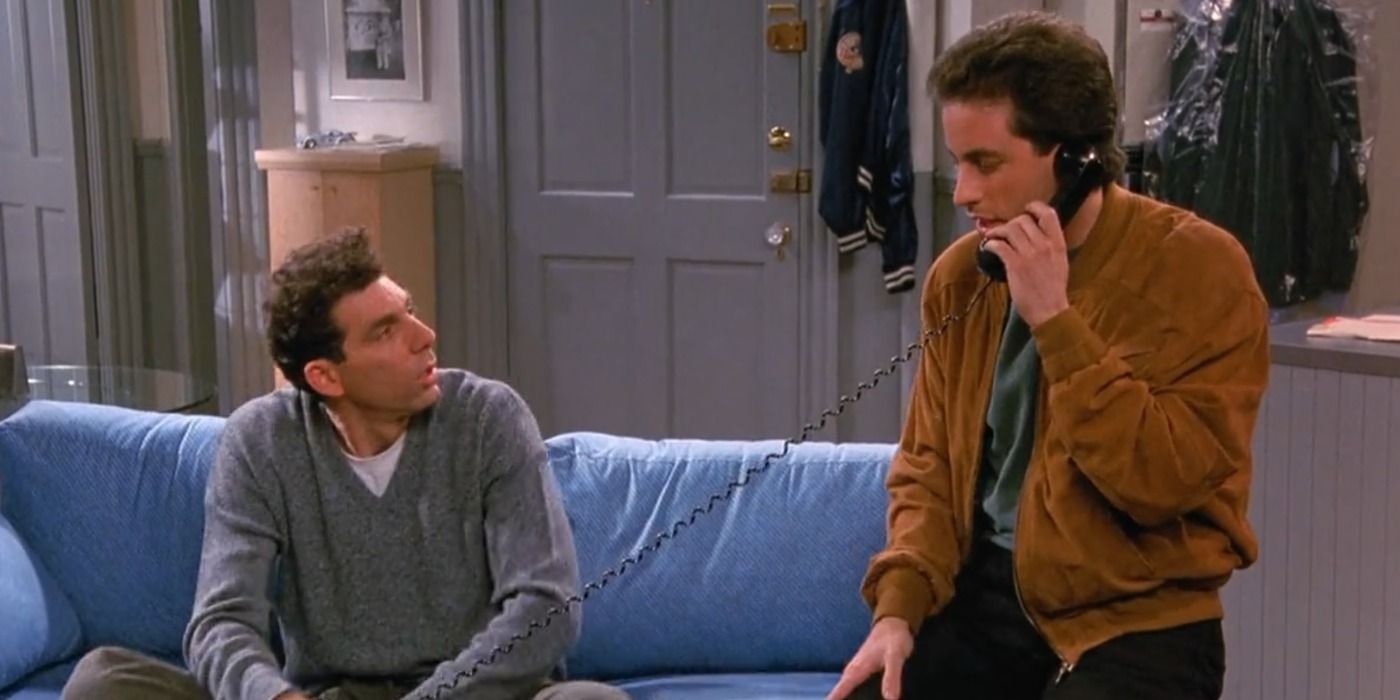 Kramer and Jerru sitting on a blue couch in Seinfeld