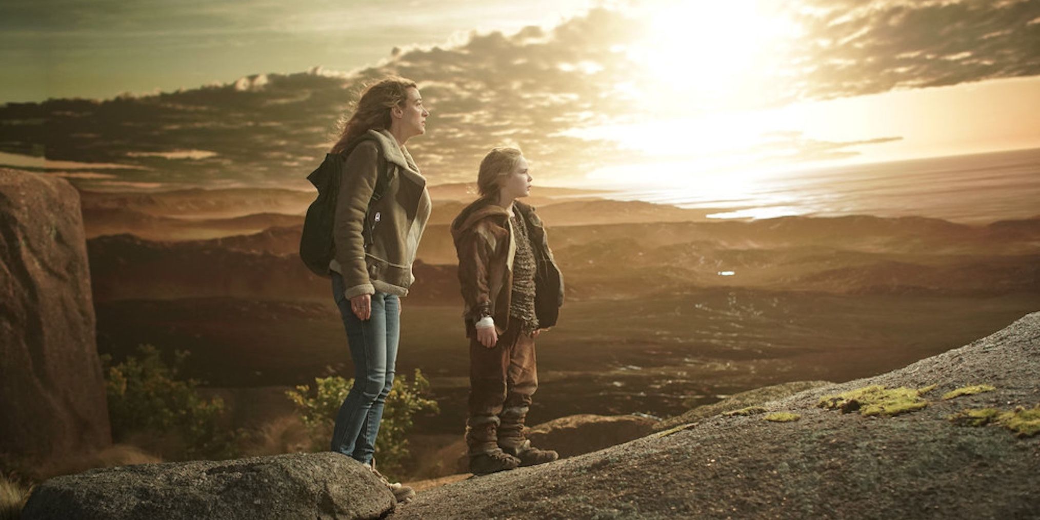 Two La Brea characters standing on a cliff while looking at the horizon