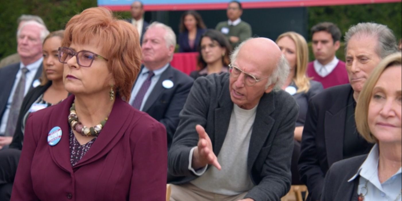 Larry pesters Irma at an election rally in Curb Your Enthusiasm
