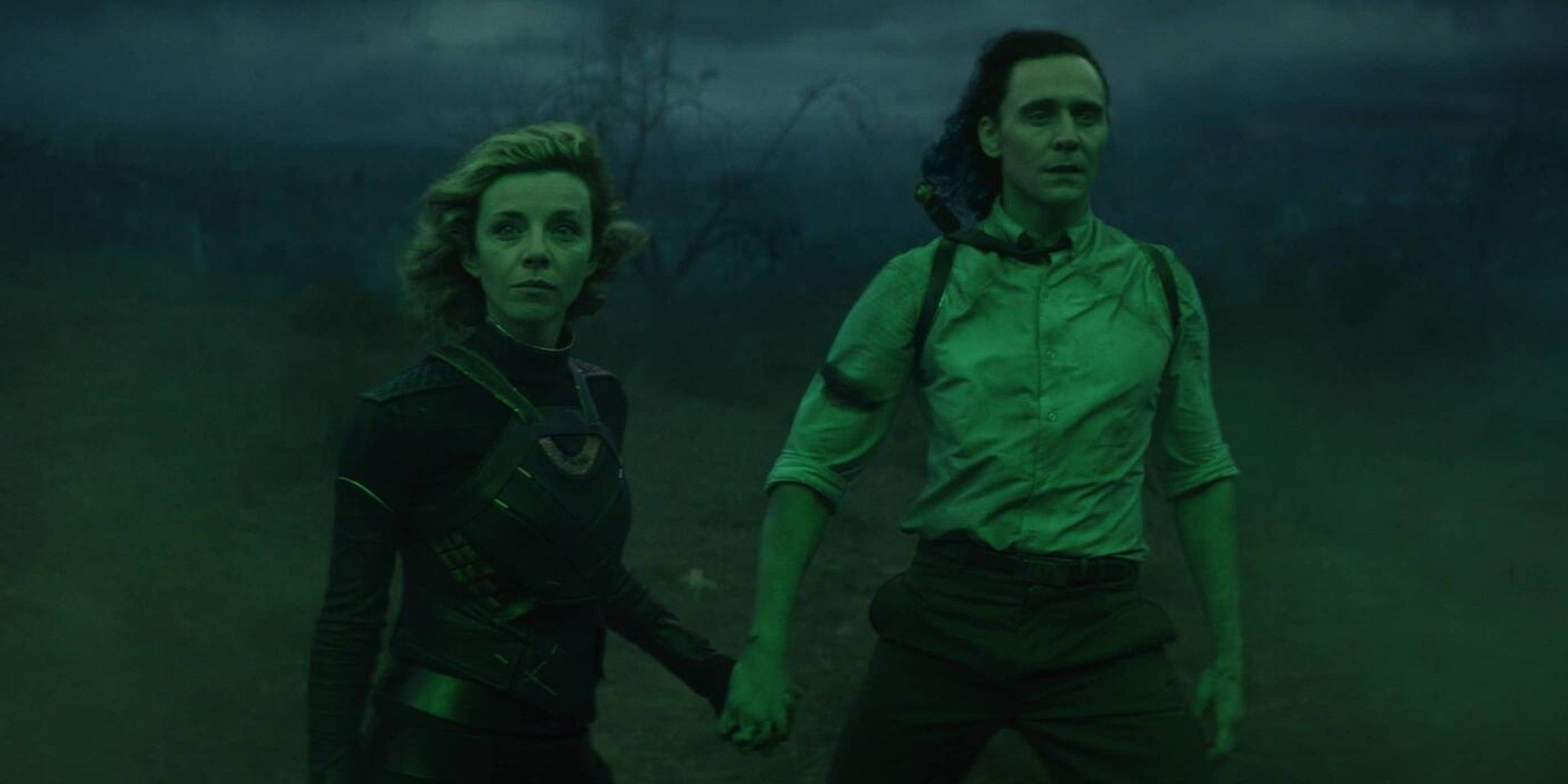 Loki and Sylvie hold hands in Loki.