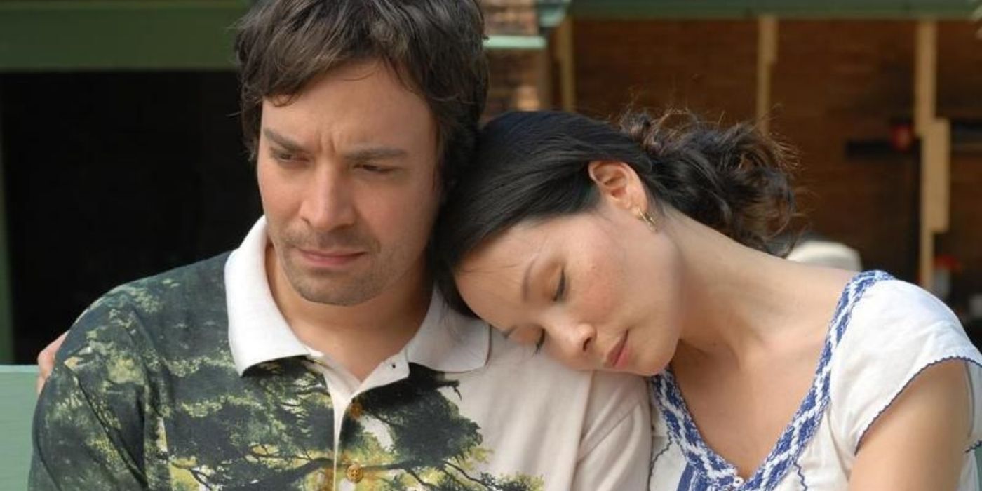 Lucy Liu resting her head on Jimmy Fallon's shoulder in a still from The Year Of Getting To Know Us
