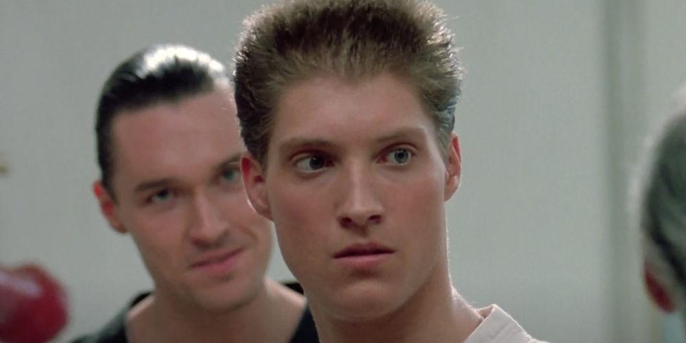Mike stands with Terry over his shoulder in The Karate Kid Part III