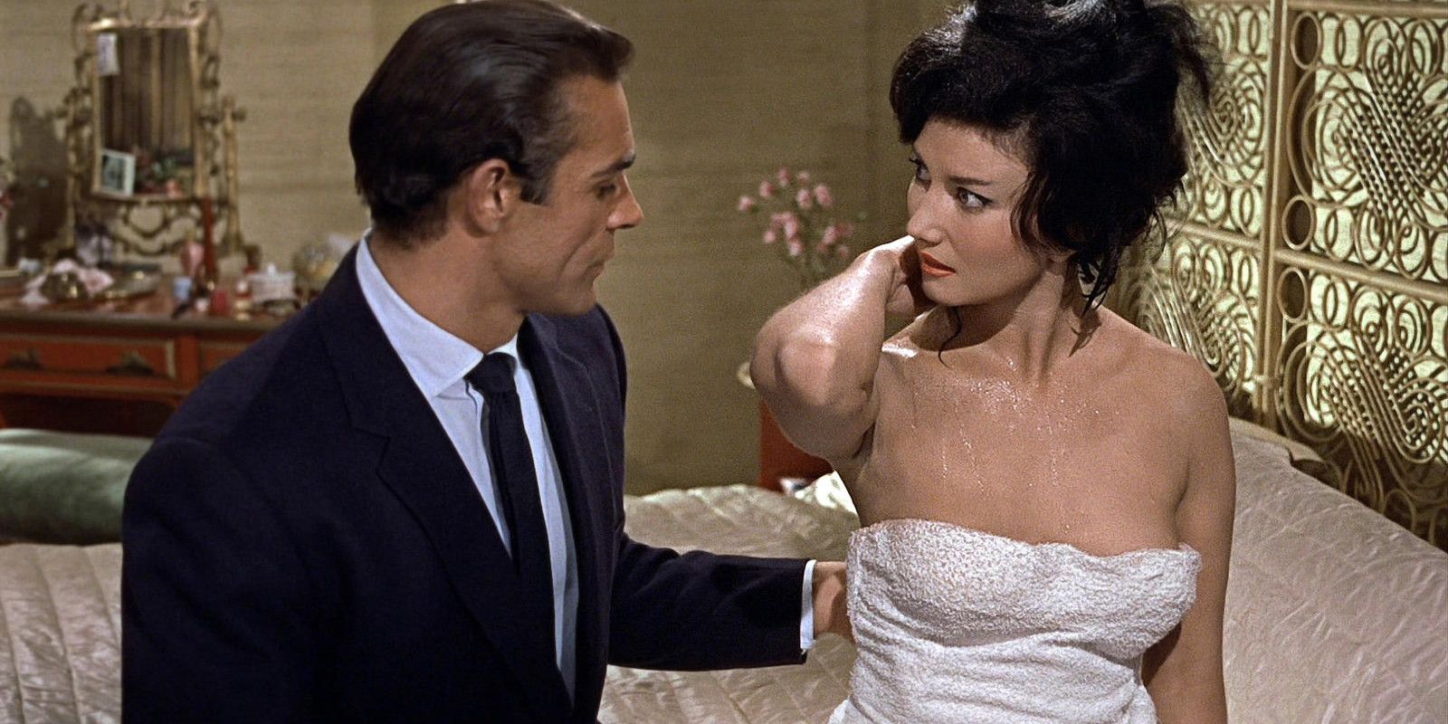 Miss Taro in a towel talks to James Bond on the bed in Dr. No.