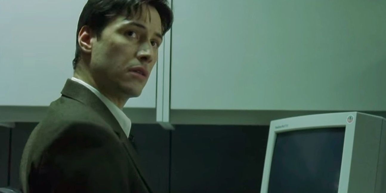 Neo looks up from his computer in The Matrix