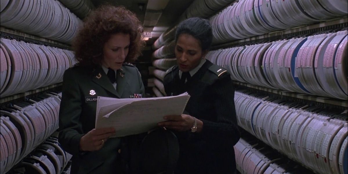 Pam Grier consults a document in The Package
