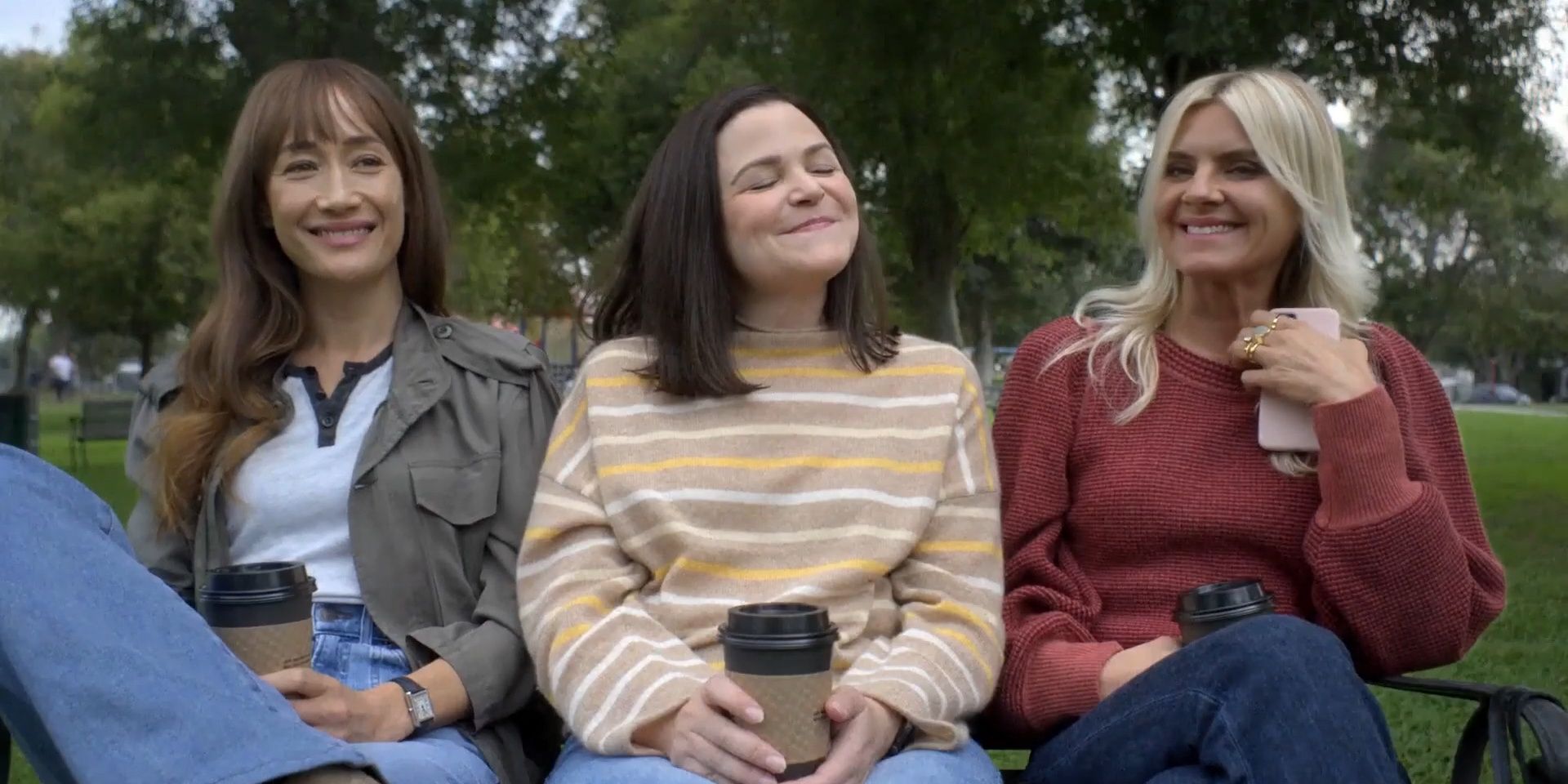The cast of Pivoting sits on a park bench