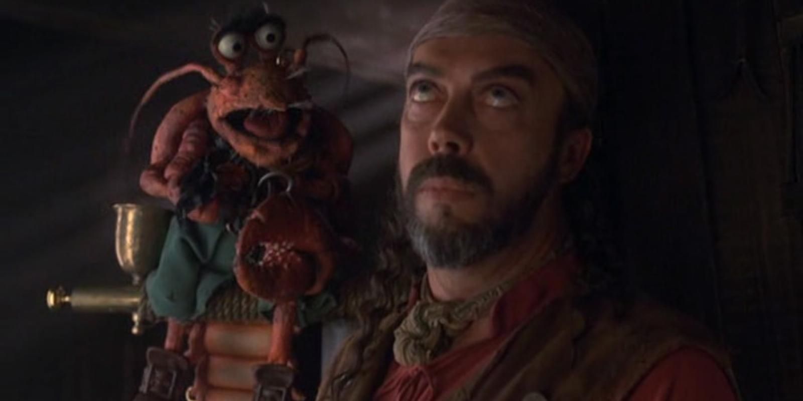 Polly Lobster laughs on Long John Silver's shoulder in Muppet Treasure Island