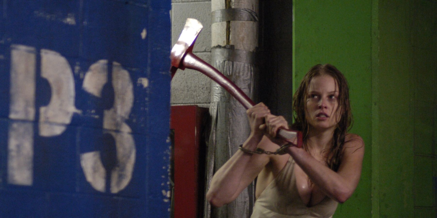 Rachel Nichols holds an ax above her head in the parking garage in P2