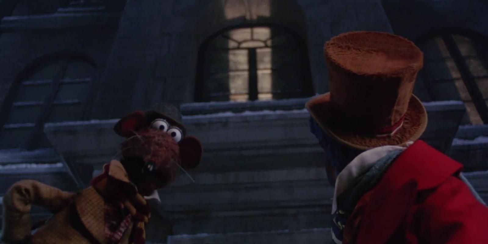 Rizzo the Rat looks at the camera outside Scrooge's home in The Muppet Christmas Carol