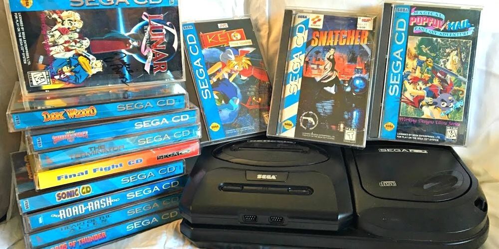A SEGA CD console is surrounded by a collection of games