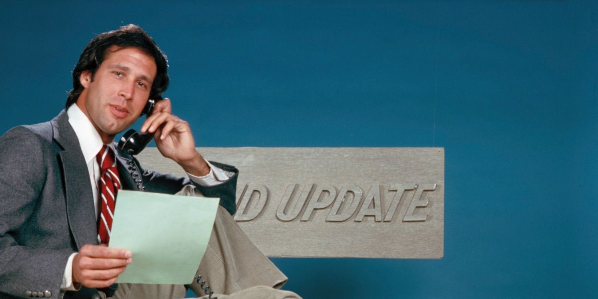 Chevy Chase holds a telephone on the set of Weekend Update.