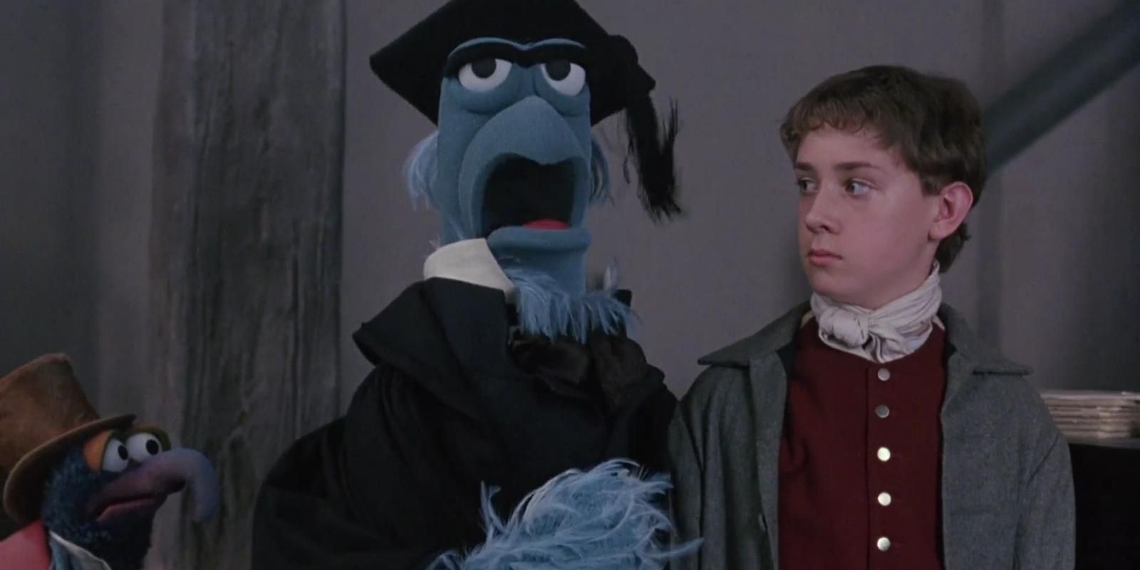 Sam Eagle stands with a young Ebenezer Scrooge in The Muppet Christmas Carol