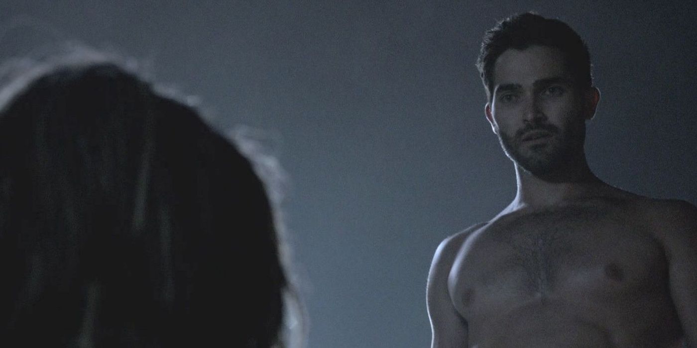 Derek from Teen Wolf stands above Kate Argent at night.