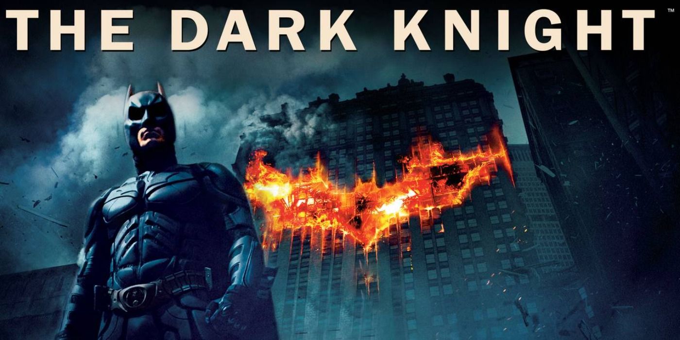Banner for The Dark Knight with Batman standing in front of a burning Bat symbol