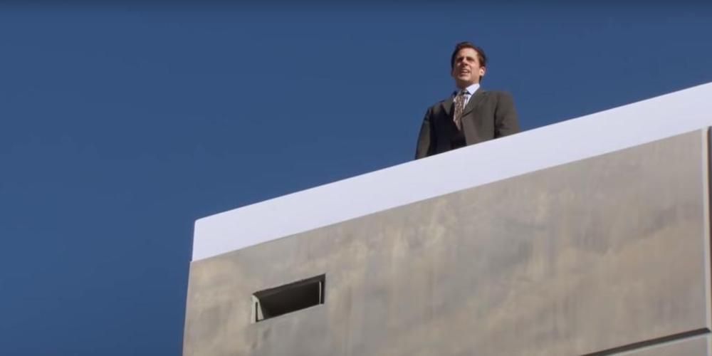 Michael stands on the Dunder-Mifflin roof.