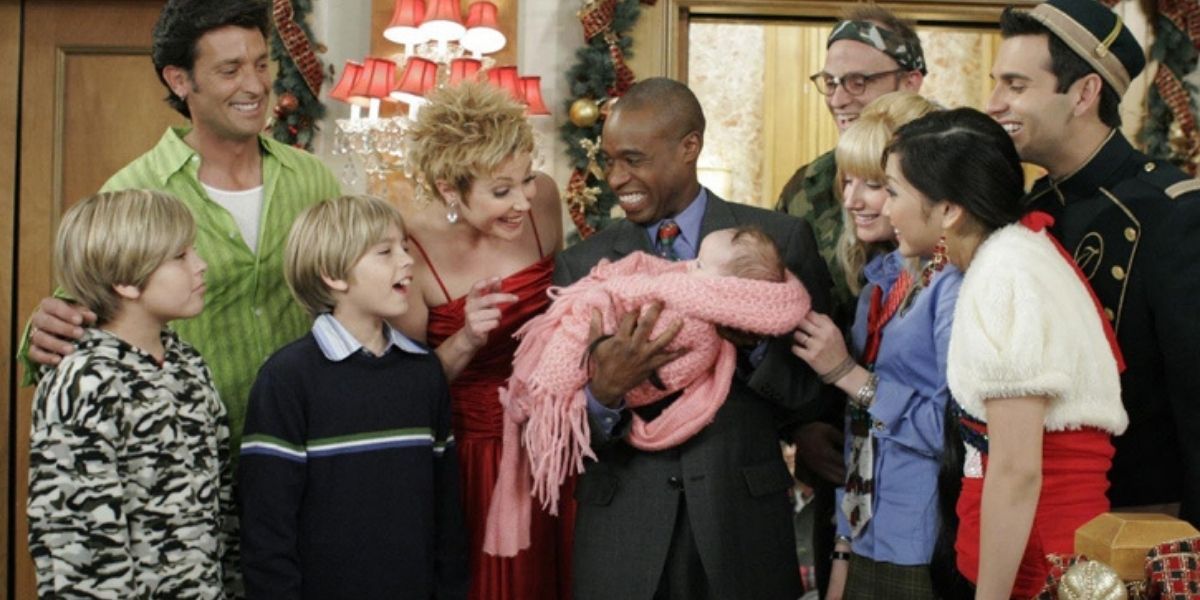 The cast of The Suite Life Of Zack and Cody around the new baby born at the Tipton