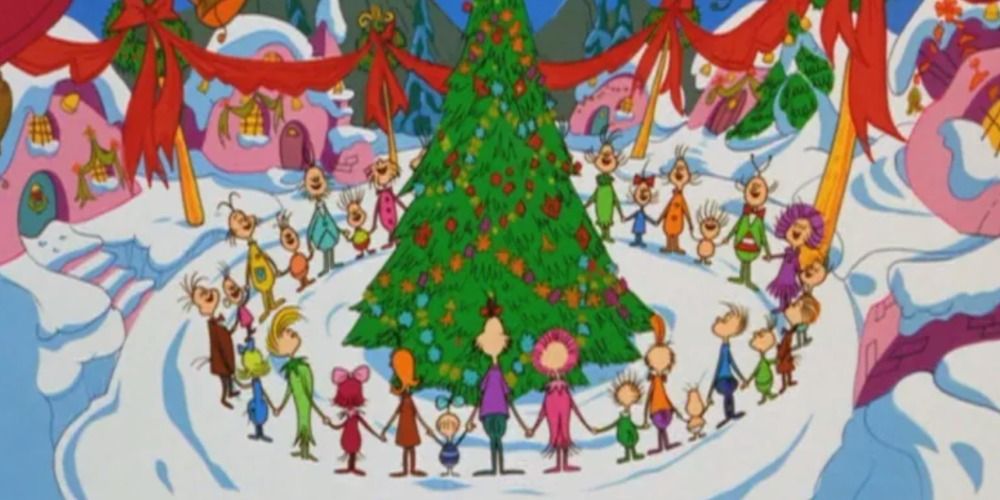 The Whos singing around the Christmas tree in Whoville in How the Grinch Stole Christmas