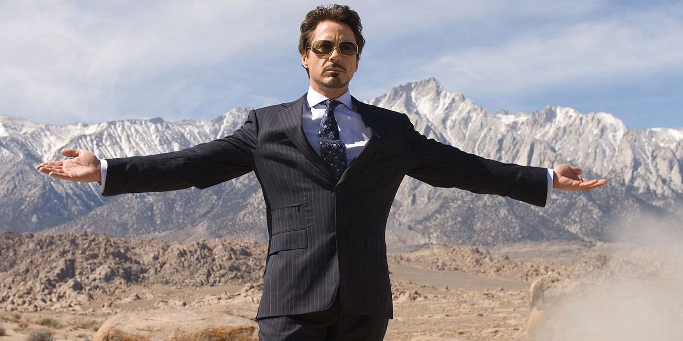 Tony Stark stretching both his arms in the desert in Iron Man