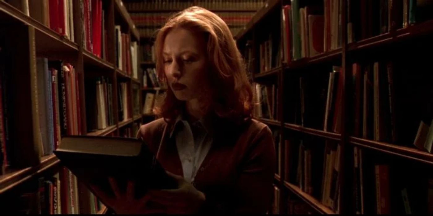 Natalie doing research in the library in Urban Legend