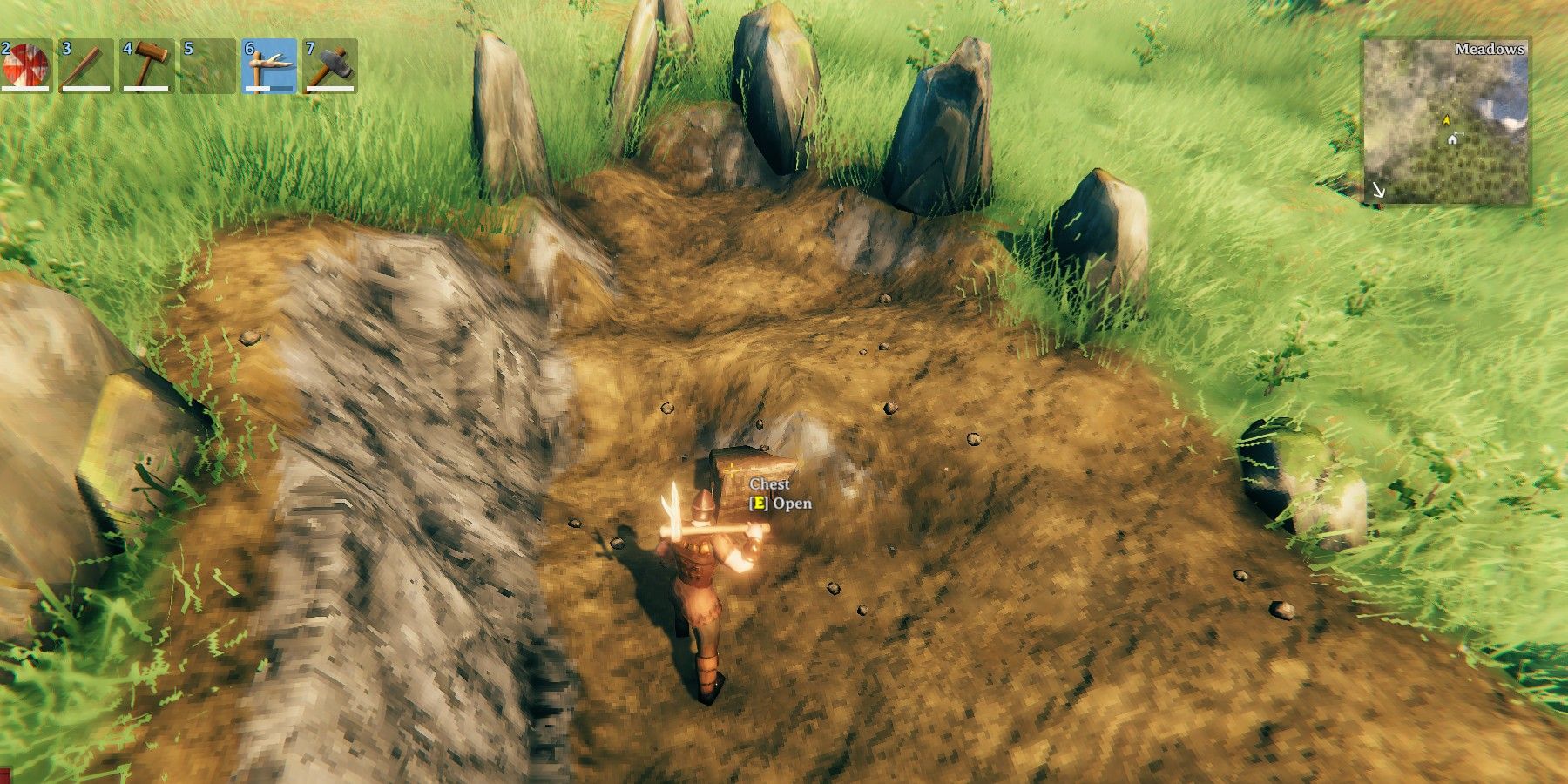 A player digs up and loots a chest from a Viking Grave in Valheim