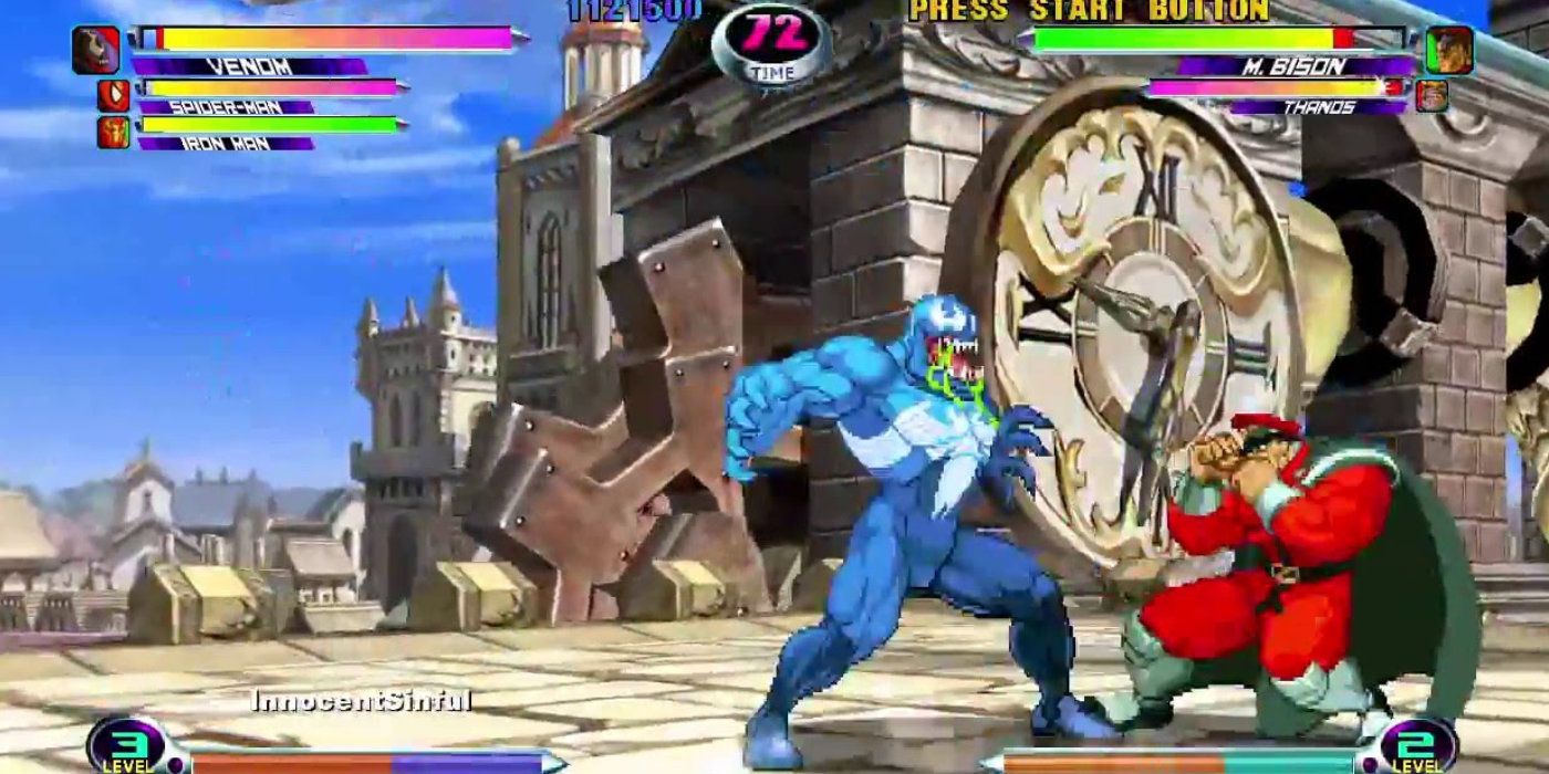 Venom, a blue Spider-Man, in marvel vs capcom 2 towers over the red clad M. Bison.