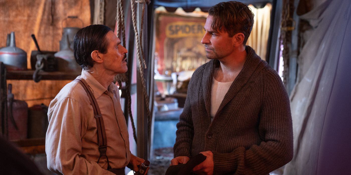 Willem Dafoe confronts Bradley Cooper in Nightmare Alley.