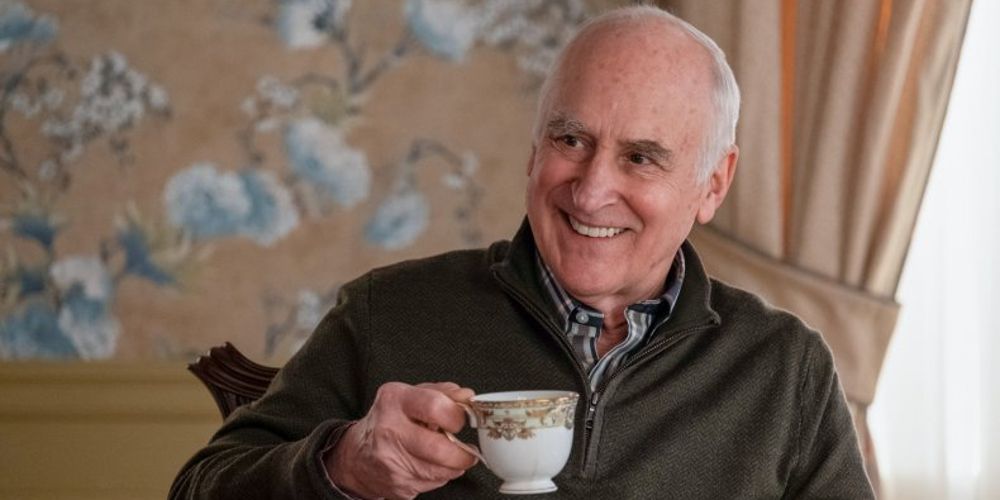 Chuck Sr. smiles and holds a teacup in Billions
