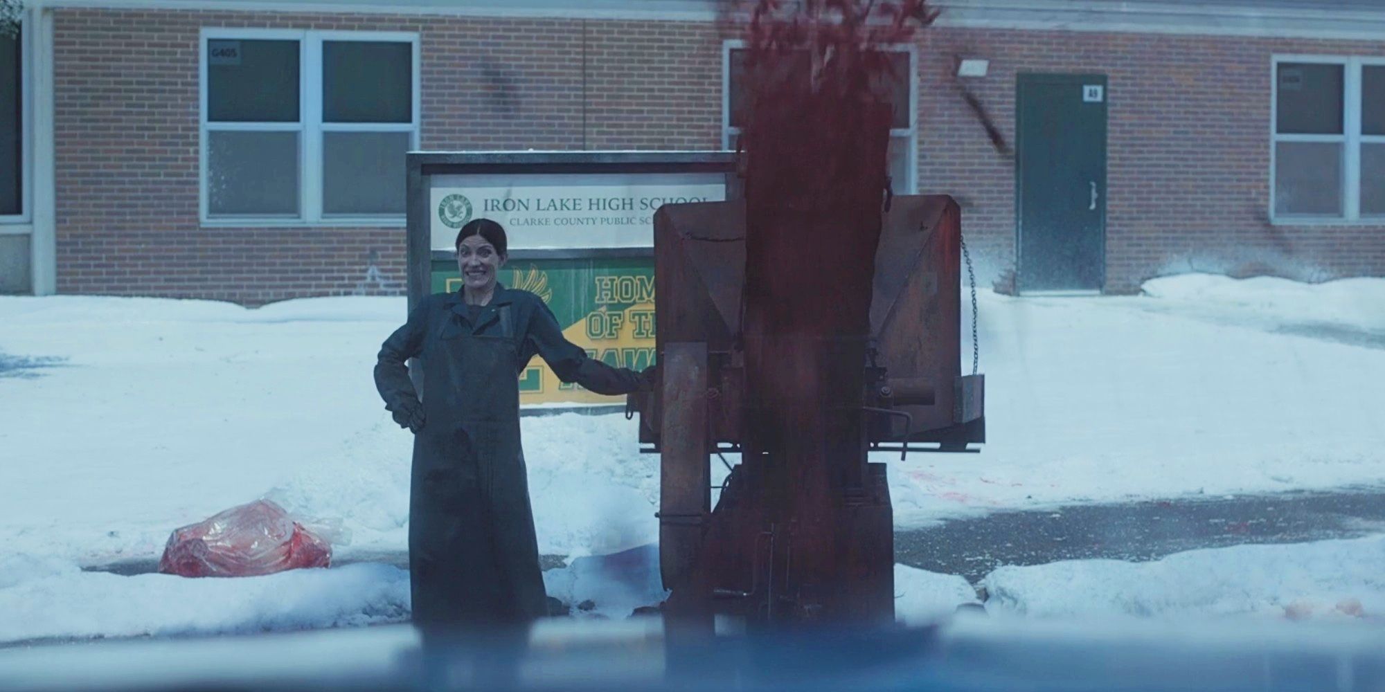 A vision of Debra smiling beside a wood chipper in Dexter: New Blood.