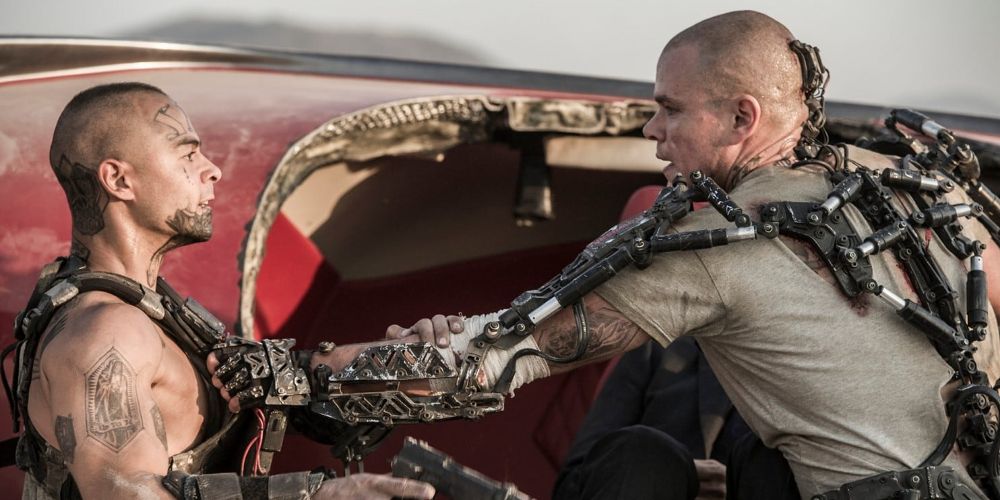 Max faces a laborer while wearing an exosuit in Elysium