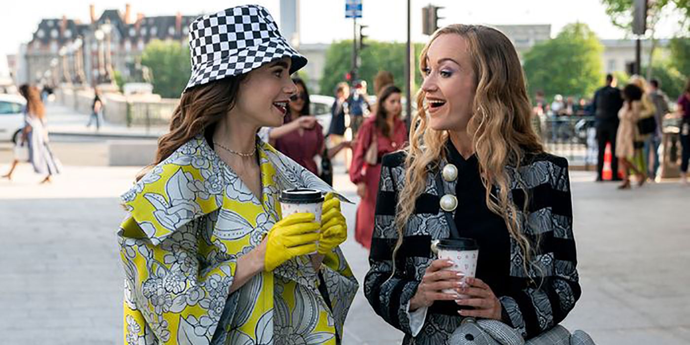 Petra and Emily drinking coffee and walking down the street in a scene from Emily in Paris.