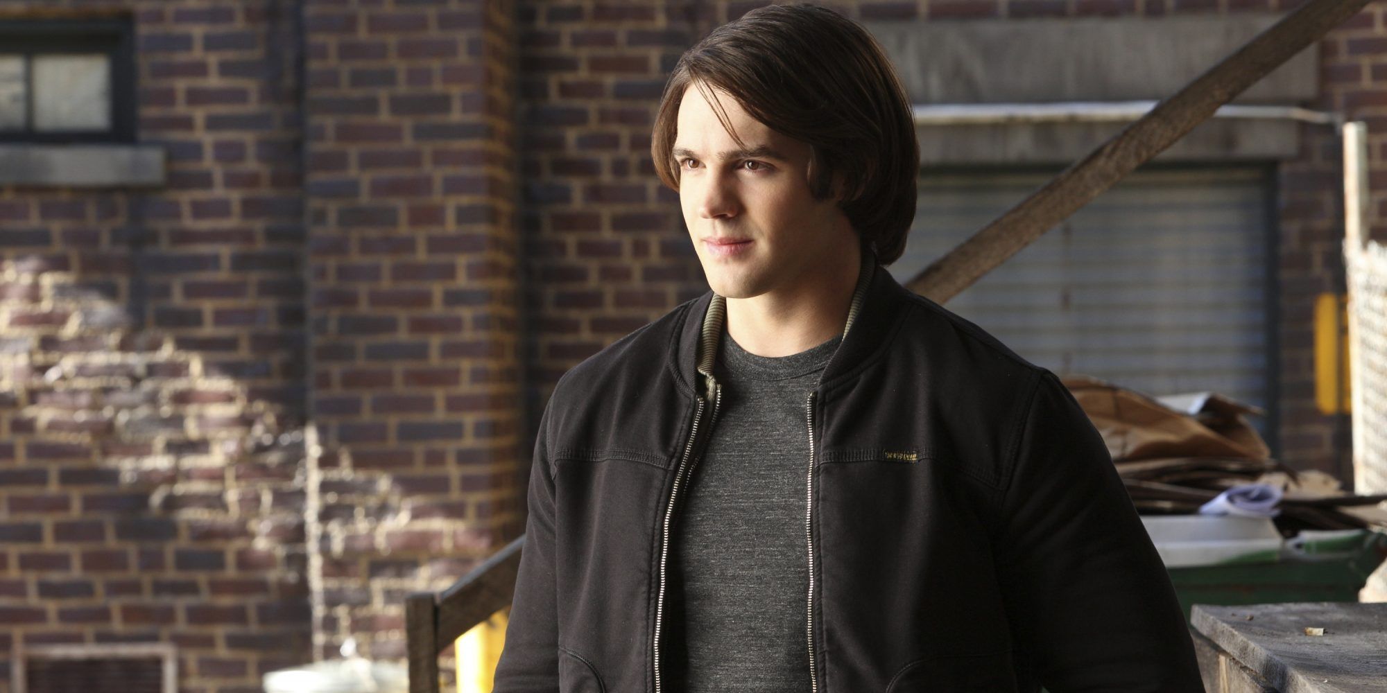 Jeremy Gilbert smiles and looks to the side in The Vampire Diaries