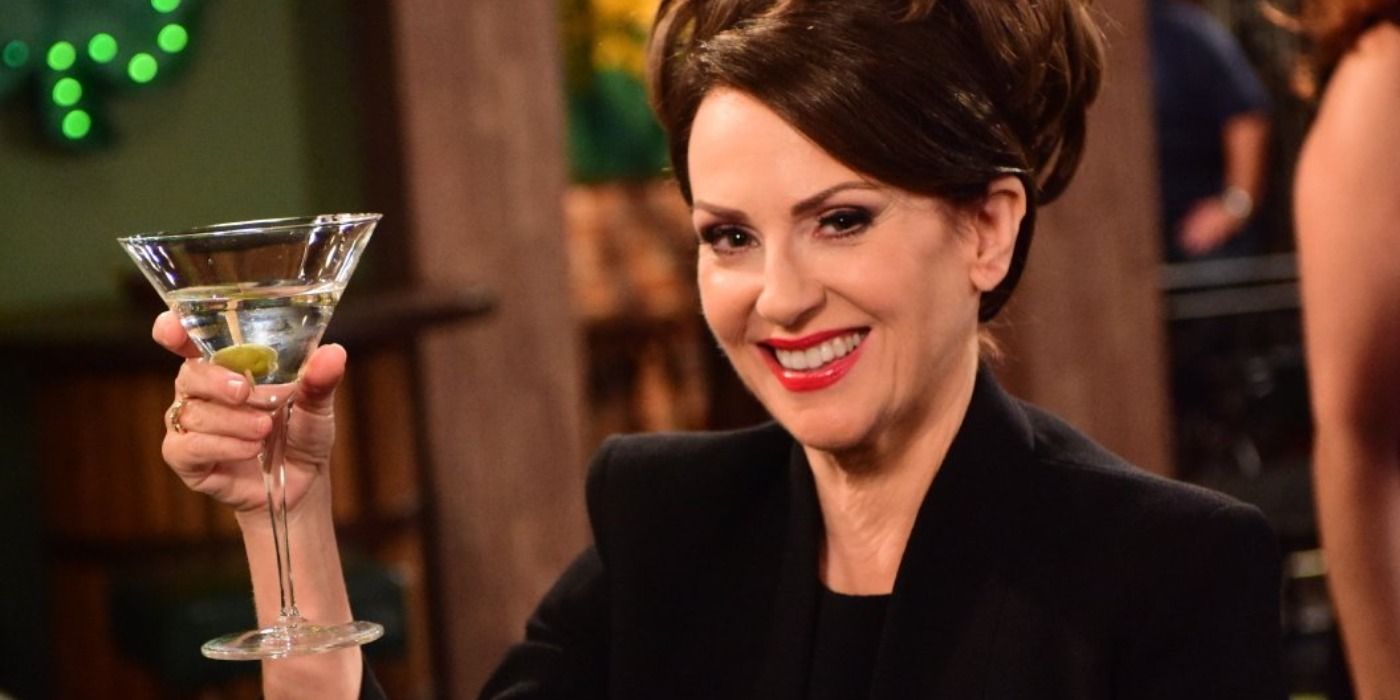 Karen Walker lifts a glass of martini in Will and Grace