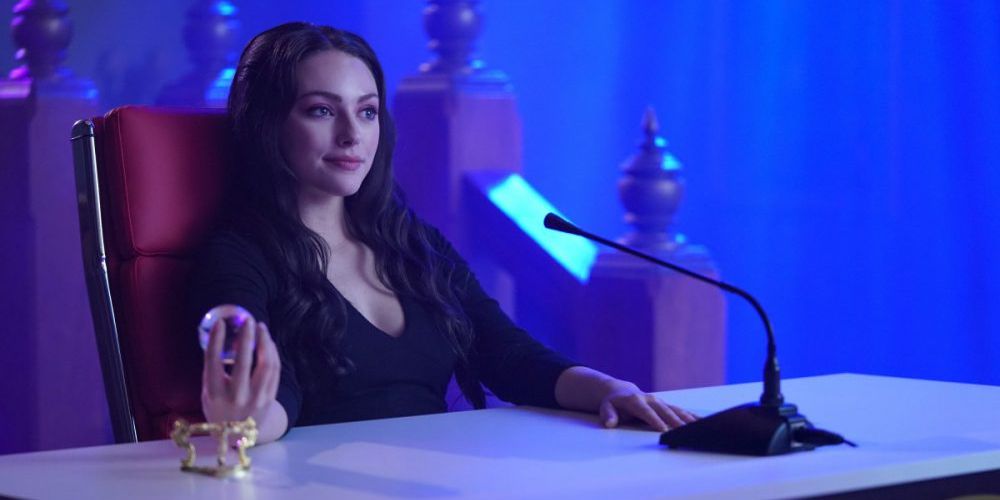 Hope sits at a table and holds a ball in Legacies