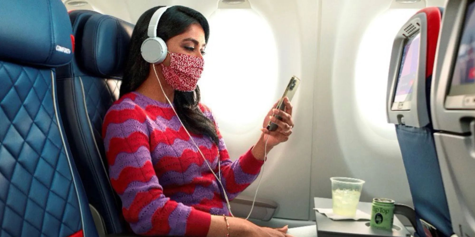 Women listening to music with headphones in-flight