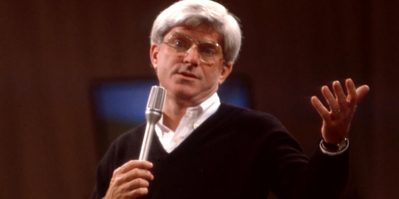 Phil Donahue holding a microphone on his talk show from the '90s.