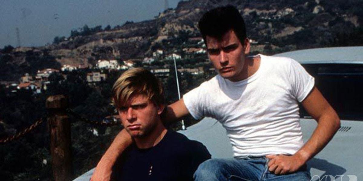 Maxwell caulfield and charlie sheen sitting on car in The Boys Next Door