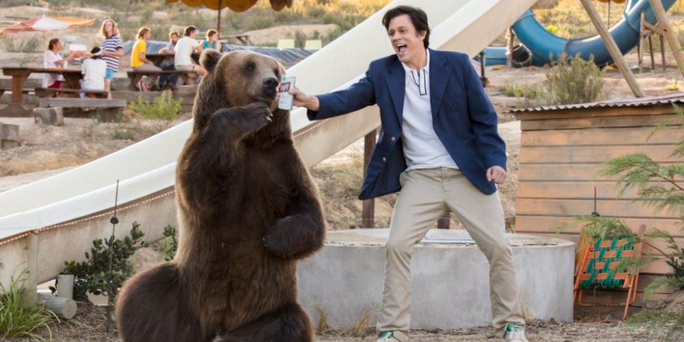 Johnny Knoxville in Action Point cheersing a bear.