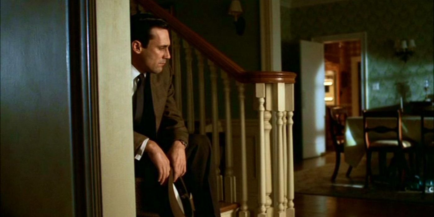 Don sits on the stairs on Mad Men