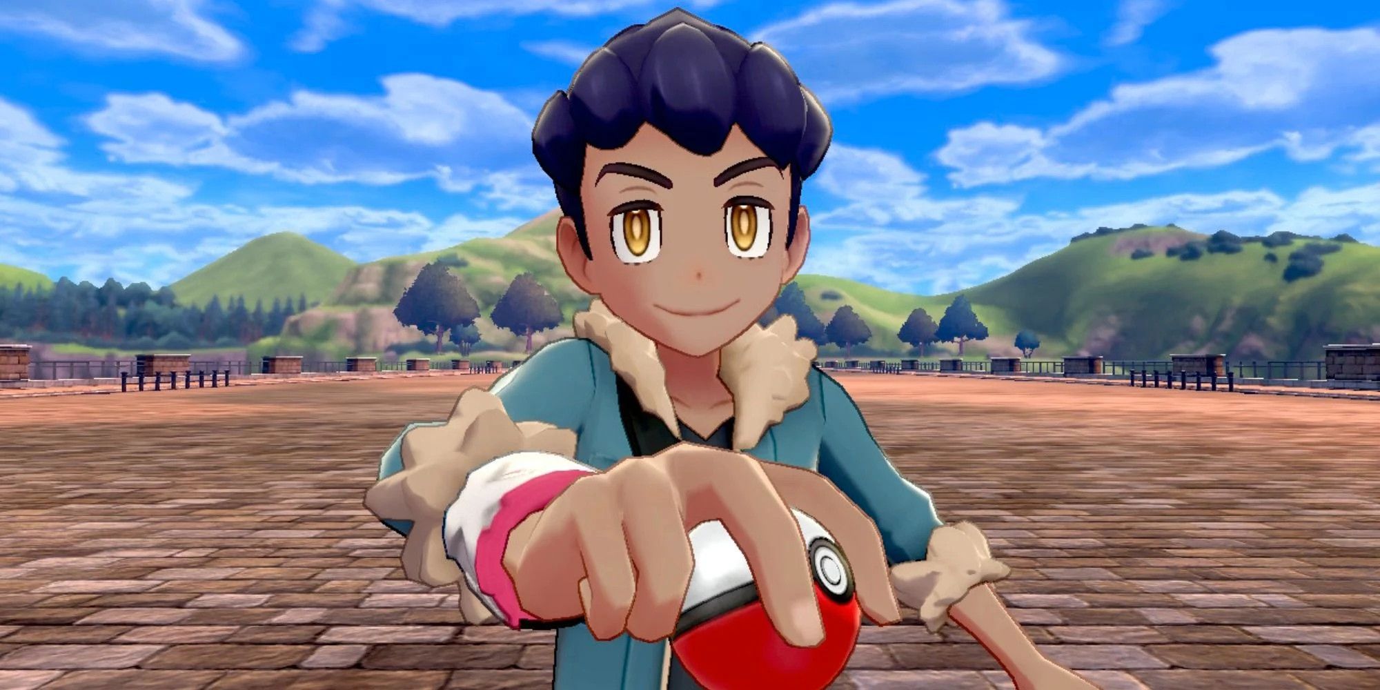 Hop holding out a ball to the camera in Pokemon Sword &amp; Shield.