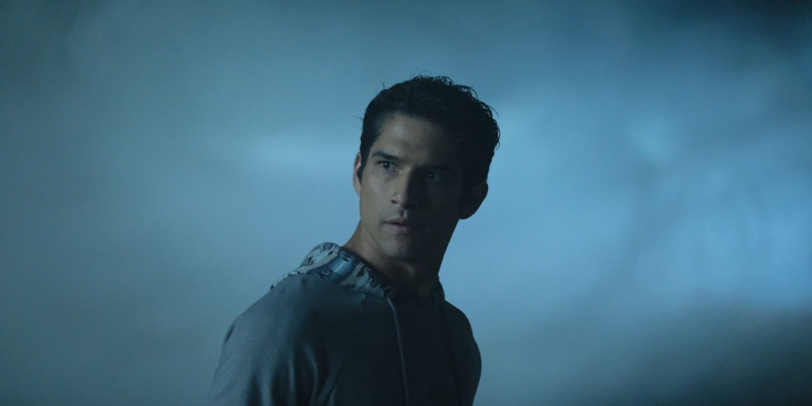 Scott Mccall looking concerned in the woods on teen wolf