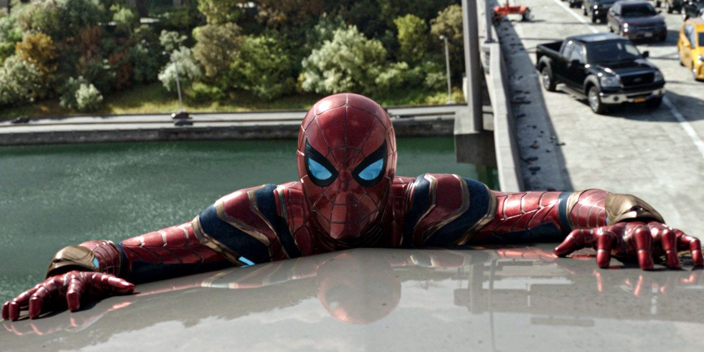 Spider-Man clinging to a car roof over a bridge