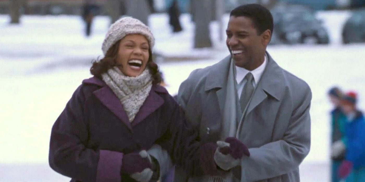 Whitney Houston and Denzel Washington walking and laughing in The Preacher's Wife