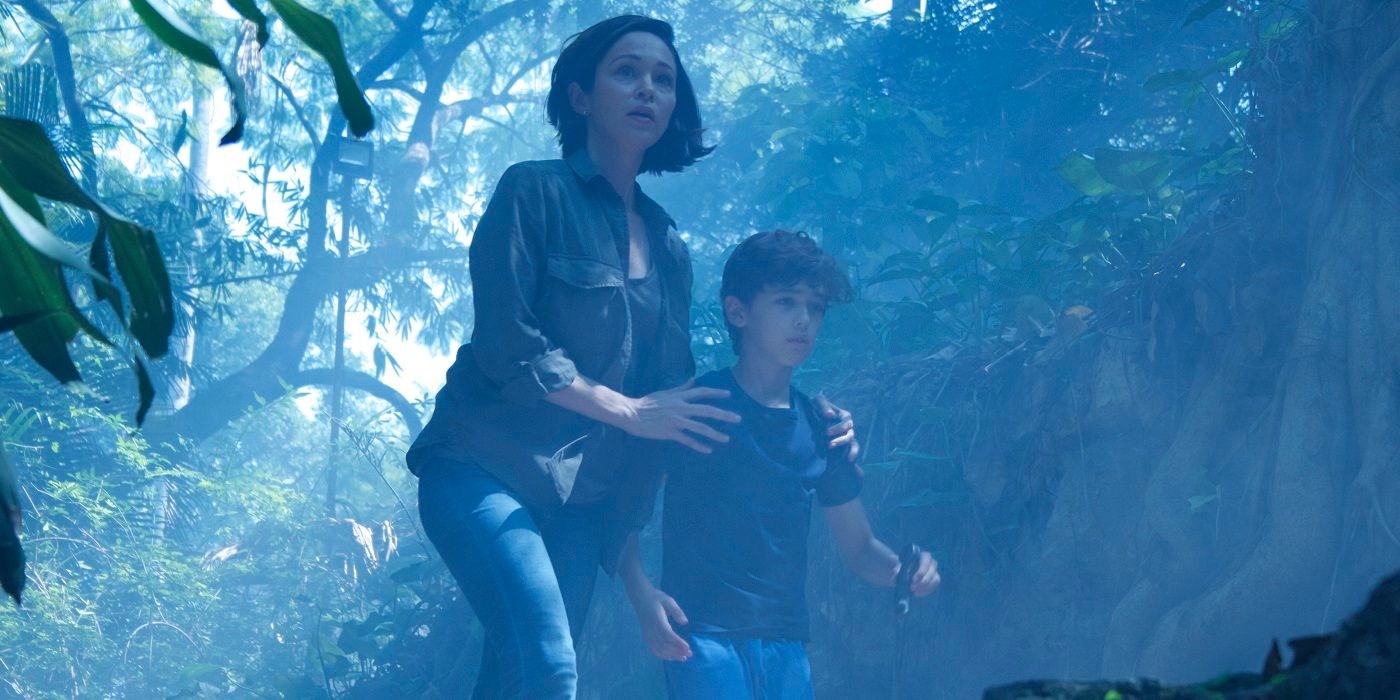 A woman and a boy wander through a forest in The Curse of La Llorona