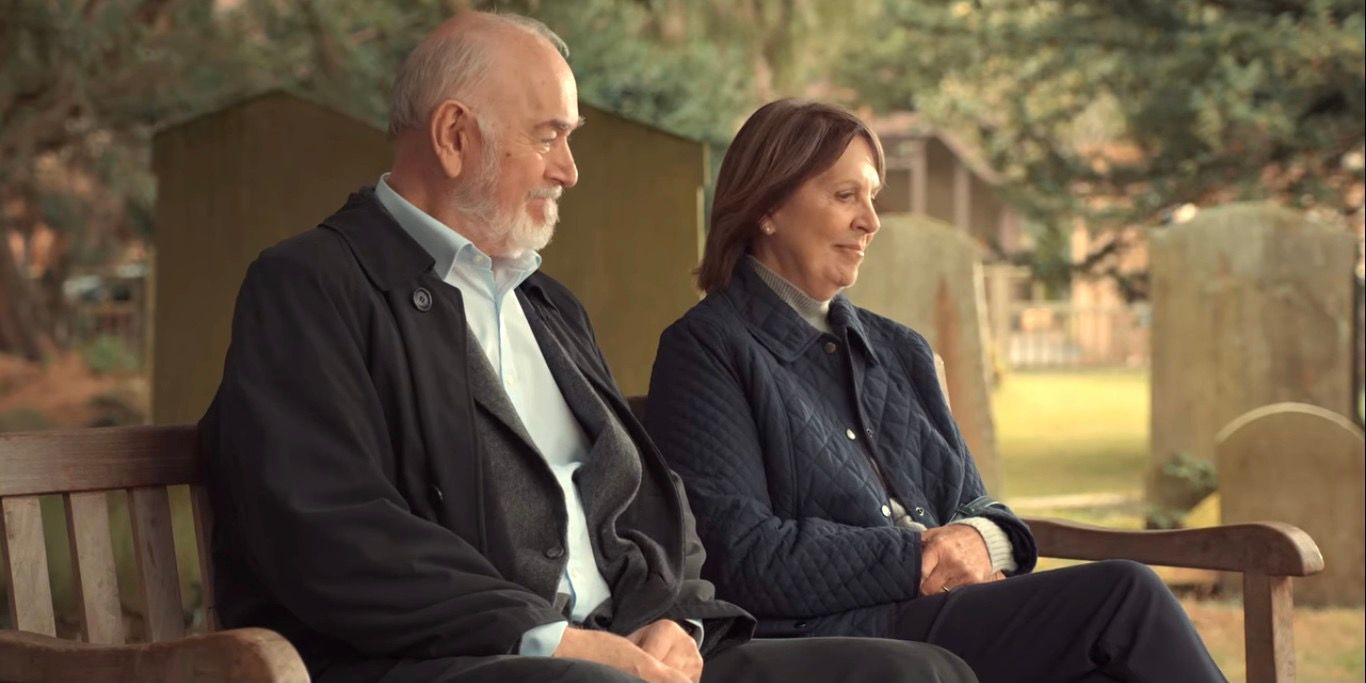 Paul and Anne sit on a bench together in After Life