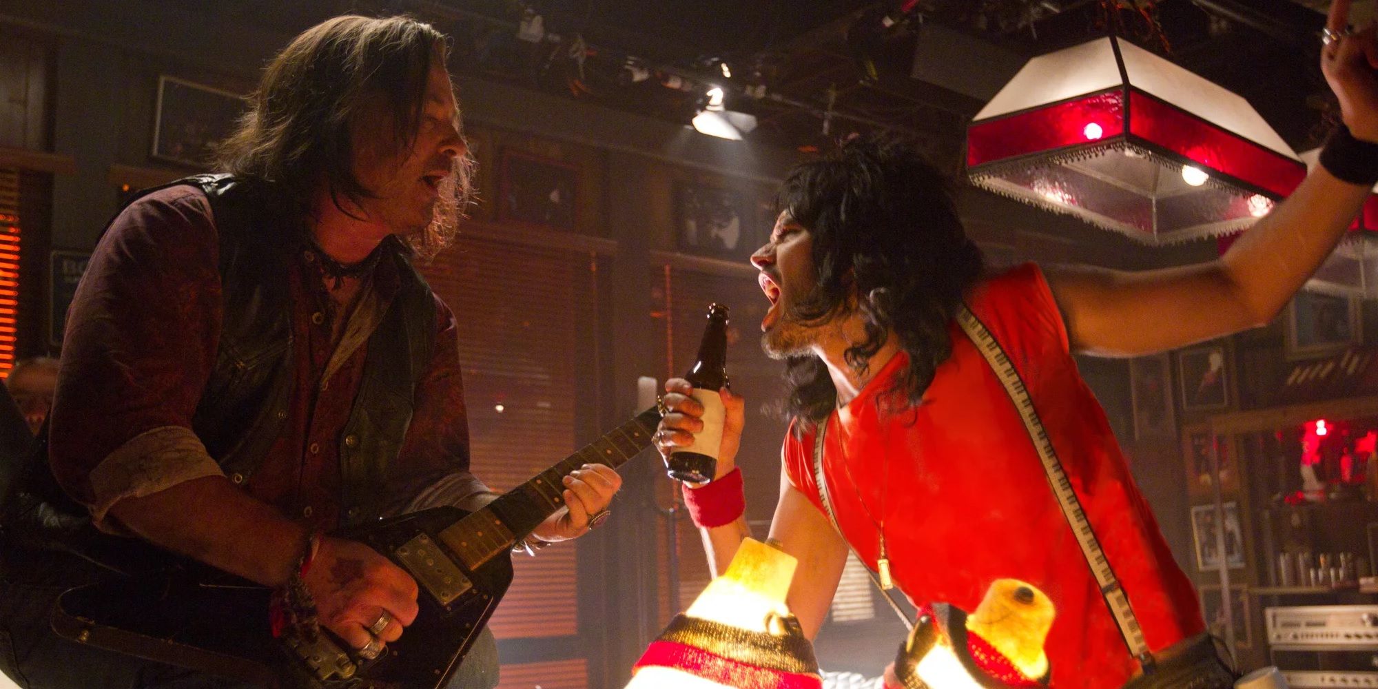 Alec Baldwin and Russell Brand playing rock music in a bar in Rock of Ages