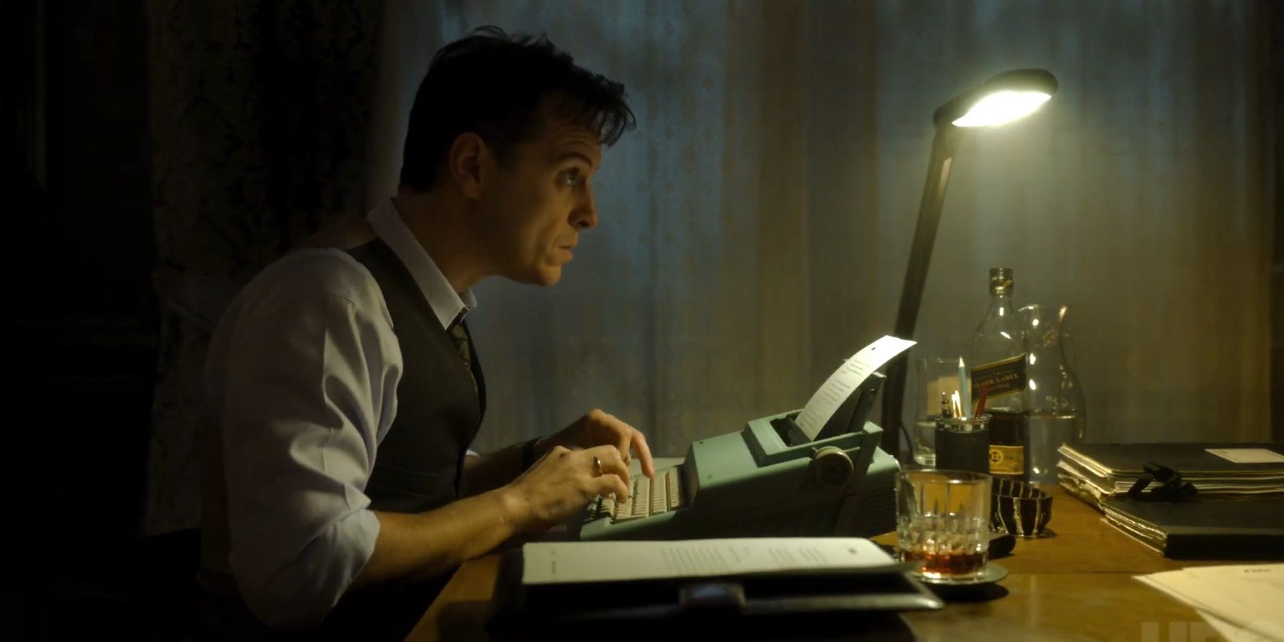 Andrew Scott sitting on a table and typing on a typewriter in Oslo