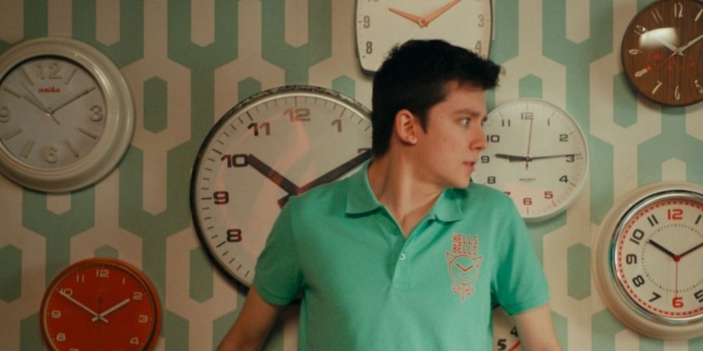 Asa Butterfield standing in front of a bunch of clocks in Right Place Wrong Tim