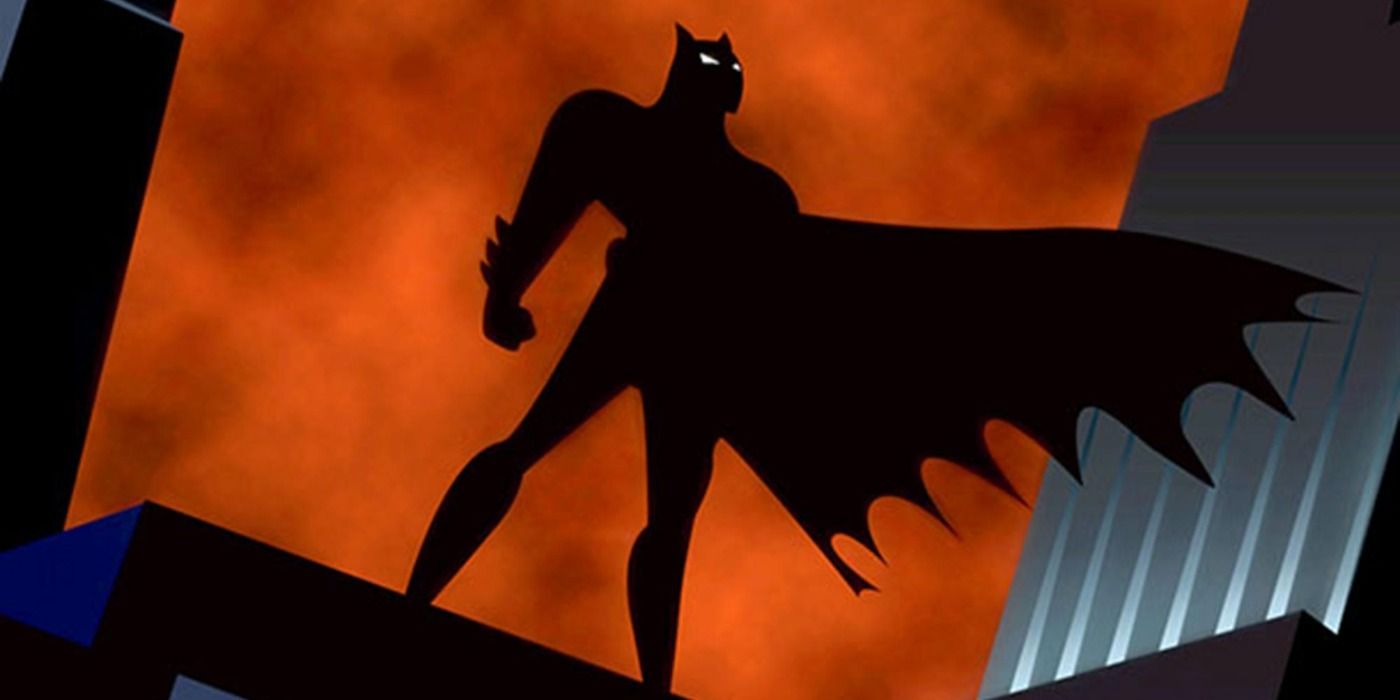 The shadowy silhouette of Batman looming over Gotham in BTAS' opening