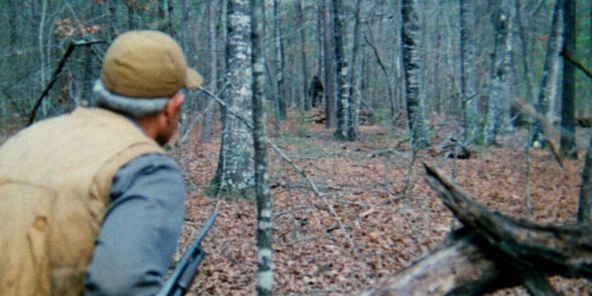 A hunter spots the Fouke monster in the distance from The Legend of Boggy Creek