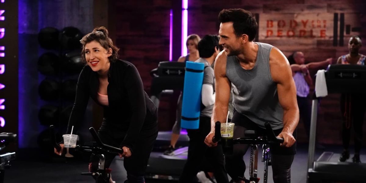 Kat on a bike at the gym in Call Me Cat